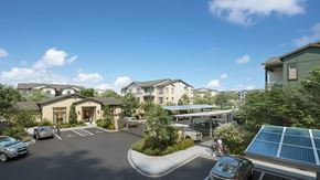 Santa Paula apartment for rent - A sunny day at a residential complex with cars parked and solar panels on the roof.