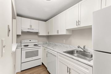 Worcester apartment for rent - a kitchen with white cabinets and appliances and a sink