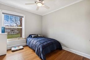 Oak Park apartment for rent - a bedroom with a bed and a ceiling fan at The Bryant at Oak Park I & II, Oak Park, IL