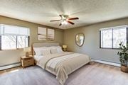 Eden Prairie apartment for rent - A bedroom with a large bed and a ceiling fan.