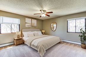 Eden Prairie apartment for rent - A bedroom with a large bed and a ceiling fan.