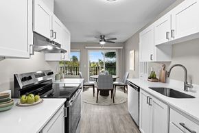 Portland apartment for rent - A modern kitchen with a dining table and chairs in the middle.