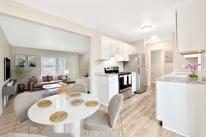 Tualatin apartment for rent - A modern kitchen with a dining table set for two.