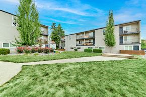 Tualatin apartment for rent - A sunny day at a residential area with apartment buildings and green lawns. at River Lofts Apartments, Tualatin