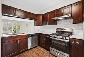 Clarendon Hills apartment for rent - A kitchen with brown cabinets and a stainless steel oven.