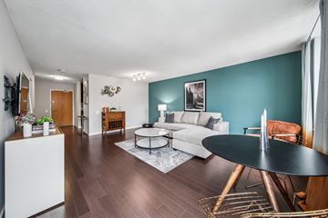 Chicago apartment for rent - A living room with a white sofa and a black coffee table.