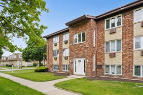 Countryside apartment for rent - A brick apartment building with a white door and windows.