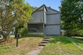 Burlington apartment for rent - A laundry facility is located in a grassy area next to a building.