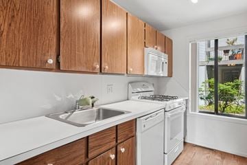 Burlington apartment for rent - A kitchen with wooden cabinets and white appliances.