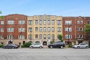 Oak Park apartment for rent - A row of three-story buildings with cars parked in front.