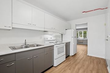 Countryside apartment for rent - A kitchen with white cabinets and a window.