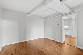 Burlington apartment for rent - A room with wooden floors and white walls.