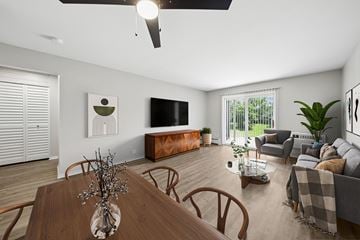 North Aurora apartment for rent - A modern living room with a wooden dining table and brown chairs.