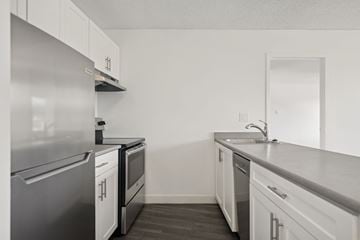 North Vancouver apartment for rent - A kitchen with white cabinets and stainless steel appliances.