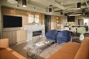 Vancouver apartment for rent - A modern living room with a fireplace and a television.