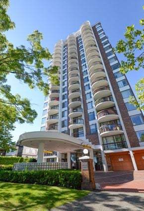 Vancouver apartment for rent - A tall residential building with balconies and a small entrance area.