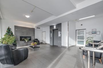 Vancouver apartment for rent - A modern living room with a fireplace and a Christmas tree.