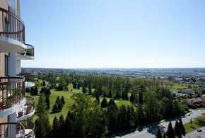 Vancouver apartment for rent - A balcony overlooks a green valley.