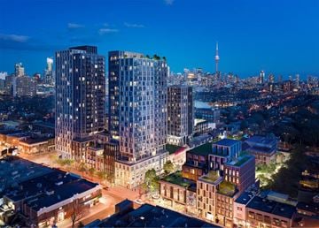 Toronto apartment for rent - A cityscape at dusk with a prominent building featuring a green roof.