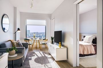 Boston apartment for rent - a living room with a couch and a table and a bed