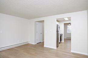 Puyallup apartment for rent - A white room with a door and a refrigerator.