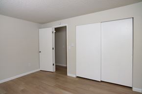 Puyallup apartment for rent - A room with a white door and two white closet doors.