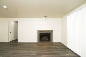 Federal Way apartment for rent - A room with a fireplace and wooden floors.