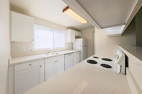 Federal Way apartment for rent - A kitchen with white appliances and cabinets.
