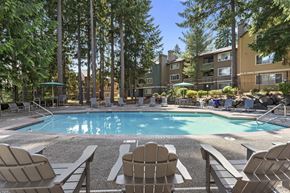 Federal Way apartment for rent - A pool surrounded by chairs and trees.