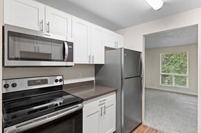Puyallup apartment for rent - Beautiful kitchen, white cabinets and stainless steel appliances.