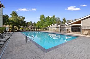 Kent apartment for rent - A swimming pool surrounded by a tiled patio and lounge chairs.