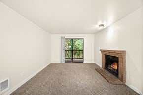 Federal Way apartment for rent - A room with a fireplace and a window with a view of trees.