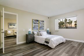 Escondido apartment for rent - A bedroom with a bed, nightstand, and a painting on the wall.