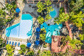 Escondido apartment for rent - An aerial view of a pool surrounded by trees and a slide.