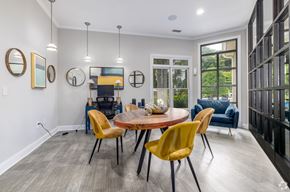 Charlotte apartment for rent - A modern dining room with a round table and yellow chairs.