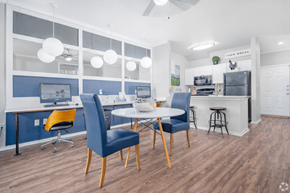 San Antonio townhouse for rent - A modern kitchen and dining area with blue chairs and a white table.