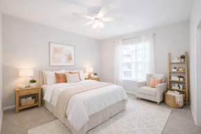 Converse apartment for rent - Converse, TX, Apartments With In-Unit Washer and Dryer - The Heights at Converse - Bedroom With White Bedding, Nightstands, Lamps, Ceiling Fan, Armchair, Bookshelf, and Large Window.