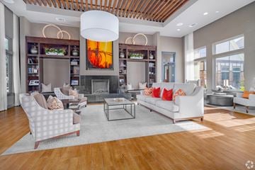 San Antonio apartment for rent - A modern living room with a fireplace and a large painting above it.