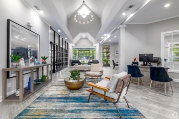 Charlotte apartment for rent - A modern living room with a large rug and a wooden chair.
