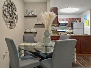 Raleigh apartment for rent - A dining room with a glass table and grey chairs.