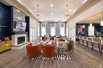 Greenville apartment for rent - A modern living room with a zebra print rug and orange chairs.