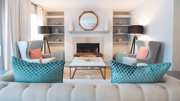 Tucker apartment for rent - A living room with a fireplace and two chairs with patterned cushions.