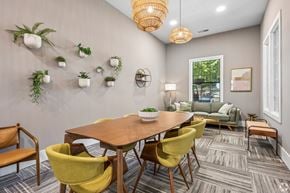 Greenville apartment for rent - A dining room with a wooden table surrounded by yellow chairs.