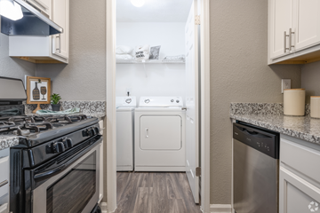 Smyrna apartment for rent - A kitchen with a black stove top oven and a white dishwasher.