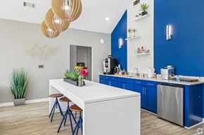 Central apartment for rent - A kitchen with a white island and blue cabinets.
