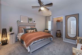 Charlotte apartment for rent - a bedroom with a bed and a ceiling fan at Whitehall Estate apartments in Charlotte NC