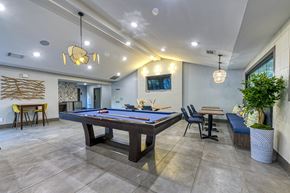 Atlanta apartment for rent - A room with a pool table and a tv mounted on the wall.