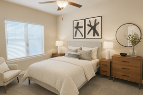 San Antonio apartment for rent - Stone Oak, TX, Apartments with In-Unit Washer and Dryer - Encore 281 Apartment Homes - Bedroom With Large Window, Ceiling Fan, Neutral Bedding, Framed Wall Art, And Wood Dresser With Round Mirror.