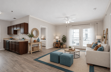 Converse apartment for rent - A living room with a white couch and a blue ottoman.