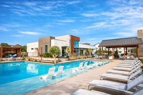 San Antonio apartment for rent - Three-Bedroom Luxury Apartments in North San Antonio, TX - Hardy Oak - Resort-Style Swimming Pool With Lounge Chairs, In-Water Loungers, Cabana, and Modern Clubhouse.